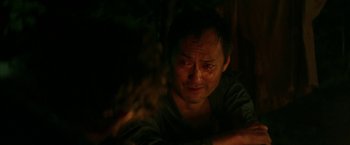 Movie still from “The Sea of Trees” (2015), directed by Gus Van Sant – A person sitting in a dark room; Close Up shot, Over the shoulder angle