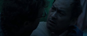 Movie still from “The Sea of Trees” (2015), directed by Gus Van Sant – A man with glasses is talking to another man; Close Up shot, Over the shoulder angle