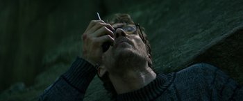 Movie still from “The Sea of Trees” (2015), directed by Gus Van Sant – A person talking on a cell phone; Close Up shot, Low angle