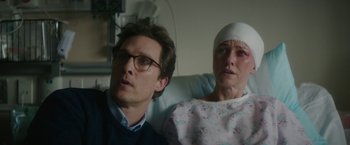 Movie still from “The Sea of Trees” (2015), directed by Gus Van Sant – A man and a woman sitting next to each other in a hospital bed; Close Up shot, Over the shoulder angle