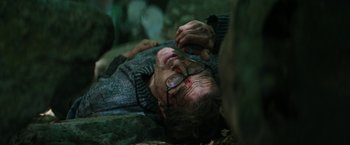 Movie still from “The Sea of Trees” (2015), directed by Gus Van Sant – A man laying on the ground with a knife in his hand; Close Up shot, High angle