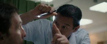 Movie still from “The Sea of Trees” (2015), directed by Gus Van Sant – A man is holding a cell phone up to his face; Extreme Close Up shot, Low angle