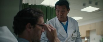 Movie still from “The Sea of Trees” (2015), directed by Gus Van Sant – A man in a white lab coat looking at another man in a white lab coat; Close Up shot, Over the shoulder angle