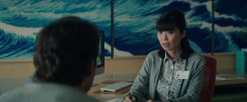 Movie still from “The Sea of Trees” (2015), directed by Gus Van Sant – A woman sitting at a desk in front of a computer; Medium shot, Over the shoulder angle