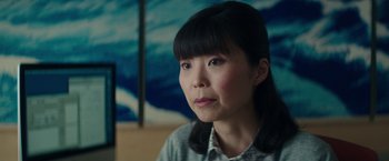 Movie still from “The Sea of Trees” (2015), directed by Gus Van Sant – A person sitting in front of a painting; Close Up shot, Over the shoulder angle