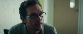 Movie still from “The Sea of Trees” (2015), directed by Gus Van Sant – A person wearing glasses; Close Up shot, Over the shoulder angle