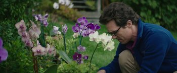 Movie still from “The Sea of Trees” (2015), directed by Gus Van Sant – A man looking at flowers in a flower bed; Close Up shot, Over the shoulder angle