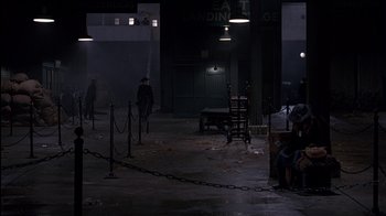 Movie still from “The Secret Garden” (1993), directed by Agnieszka Holland – A man sitting on a chair in a dark room; Wide shot, High angle