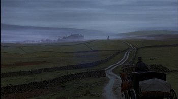 Movie still from “The Secret Garden” (1993), directed by Agnieszka Holland – A horse and buggy traveling down a road in a field; Extreme Wide shot, High angle
