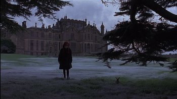 Movie still from “The Secret Garden” (1993), directed by Agnieszka Holland – A woman standing in front of an old mansion; Extreme Wide shot, Low angle