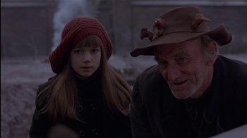 Movie still from “The Secret Garden” (1993), directed by Agnieszka Holland – An older man and a young girl are looking at the camera; Close Up shot, Over the shoulder angle