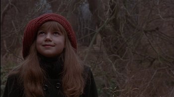 Movie still from “The Secret Garden” (1993), directed by Agnieszka Holland – A young girl wearing a red hat looking up at the sky; Close Up shot, Low angle