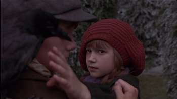 Movie still from “The Secret Garden” (1993), directed by Agnieszka Holland – A little girl wearing a red hat looking at an older man; Close Up shot, Over the shoulder angle