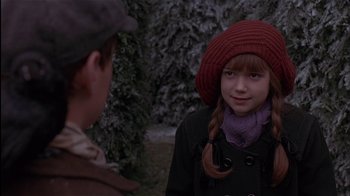 Movie still from “The Secret Garden” (1993), directed by Agnieszka Holland – A young girl wearing a red hat and a red scarf; Close Up shot, Over the shoulder angle
