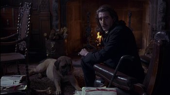 Movie still from “The Secret Garden” (1993), directed by Agnieszka Holland – A man sitting on a chair next to a dog; Medium shot, Over the shoulder angle