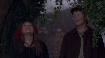 Movie still from “The Secret Garden” (1993), directed by Agnieszka Holland – Two children standing next to each other under a tree; Medium shot, Low angle