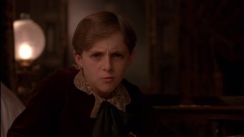 Movie still from “The Secret Garden” (1993), directed by Agnieszka Holland – A young boy in a brown shirt and a brown jacket; Close Up shot, Over the shoulder angle