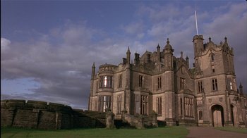 Movie still from “The Secret Garden” (1993), directed by Agnieszka Holland – An old mansion with a cloudy sky in the background; Extreme Wide shot, Low angle