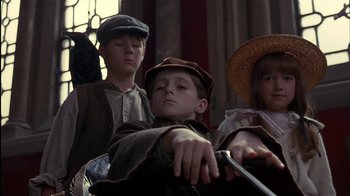Movie still from “The Secret Garden” (1993), directed by Agnieszka Holland – A group of children wearing hats and holding a stick; Medium shot, Low angle