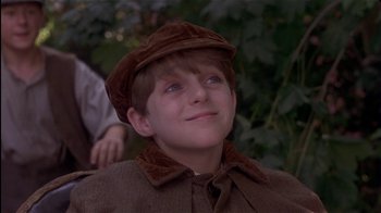 Movie still from “The Secret Garden” (1993), directed by Agnieszka Holland – A young boy wearing a brown hat looking up at the sky; Close Up shot, Low angle