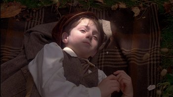 Movie still from “The Secret Garden” (1993), directed by Agnieszka Holland – A young boy wearing a hat and a tie; Close Up shot, High angle