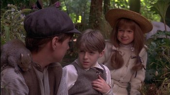 Movie still from “The Secret Garden” (1993), directed by Agnieszka Holland – A boy and two girls are standing in the woods; Close Up shot, Over the shoulder angle