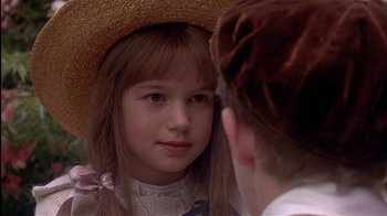 Movie still from “The Secret Garden” (1993), directed by Agnieszka Holland – A young girl looking into a mirror while wearing a straw hat; Close Up shot, Over the shoulder angle