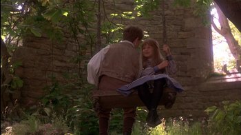 Movie still from “The Secret Garden” (1993), directed by Agnieszka Holland – A man and a woman sitting on a swing; Medium shot, High angle