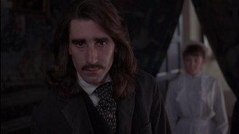 Movie still from “The Secret Garden” (1993), directed by Agnieszka Holland – A man with long hair wearing a suit and tie; Close Up shot, Low angle