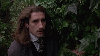 Movie still from “The Secret Garden” (1993), directed by Agnieszka Holland – A man with long brown hair wearing a suit and tie; Close Up shot, Low angle