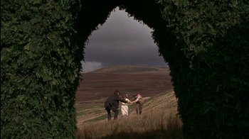 Movie still from “The Secret Garden” (1993), directed by Agnieszka Holland – Two men and a woman are standing on a hill; Extreme Wide shot, Low angle