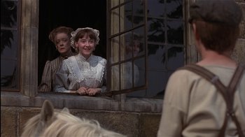 Movie still from “The Secret Garden” (1993), directed by Agnieszka Holland – Two people sitting on a window ledge looking out a window; Medium shot, Over the shoulder angle