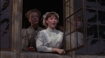 Movie still from “The Secret Garden” (1993), directed by Agnieszka Holland – Two women are standing in front of a window; Medium shot, Low angle
