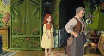 Movie still from “The Secret World of Arrietty” (2010), directed by Hiromasa Yonebayashi – A woman standing next to a man in front of a door; Medium shot, Over the shoulder angle
