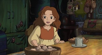 Movie still from “The Secret World of Arrietty” (2010), directed by Hiromasa Yonebayashi – A girl sitting in front of a bowl of food; Medium shot, High angle