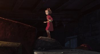 Movie still from “The Secret World of Arrietty” (2010), directed by Hiromasa Yonebayashi – A girl standing on top of a rock in a dark room; Wide shot, High angle