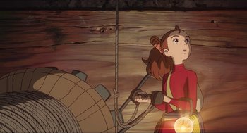 Movie still from “The Secret World of Arrietty” (2010), directed by Hiromasa Yonebayashi – An animated picture of a girl holding a rope; Medium shot, Low angle