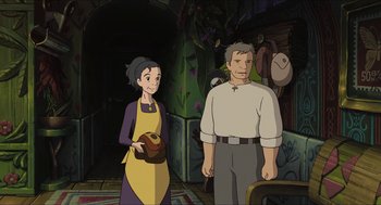 Movie still from “The Secret World of Arrietty” (2010), directed by Hiromasa Yonebayashi – An old man and a young woman standing next to each other; Medium shot, Over the shoulder angle