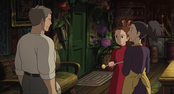 Movie still from “The Secret World of Arrietty” (2010), directed by Hiromasa Yonebayashi – A group of people standing in a living room; Medium shot, Over the shoulder angle