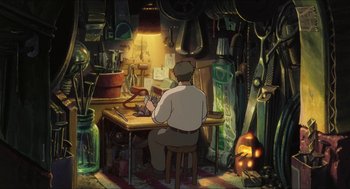Movie still from “The Secret World of Arrietty” (2010), directed by Hiromasa Yonebayashi – A man sitting at a desk in a room filled with lots of stuff; Wide shot, High angle