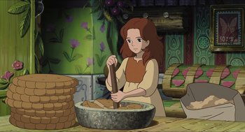 Movie still from “The Secret World of Arrietty” (2010), directed by Hiromasa Yonebayashi – A woman is making food in a large bowl; Medium shot, Over the shoulder angle
