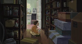Movie still from “The Secret World of Arrietty” (2010), directed by Hiromasa Yonebayashi – A cartoon of a person sitting in a kitchen; Wide shot, High angle