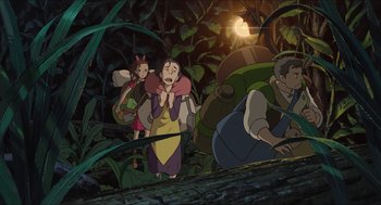 Movie still from “The Secret World of Arrietty” (2010), directed by Hiromasa Yonebayashi – A group of people standing in the woods at night; Wide shot, High angle