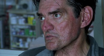 Movie still from “The Secret of the Grain” (2007), directed by Abdellatif Kechiche – A man's face looking angry; Close Up shot, Low angle