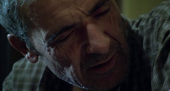Movie still from “The Secret of the Grain” (2007), directed by Abdellatif Kechiche – An older man with a beard and a mustache; Close Up shot, Low angle