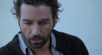 Movie still from “The Secret of the Grain” (2007), directed by Abdellatif Kechiche – A person wearing a jacket; Close Up shot, Over the shoulder angle