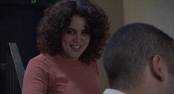 Movie still from “The Secret of the Grain” (2007), directed by Abdellatif Kechiche – A woman with curly brown hair smiling at a man; Close Up shot, Over the shoulder angle