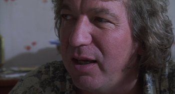 Movie still from “The Secret of the Grain” (2007), directed by Abdellatif Kechiche – A person's face with a frowning look; Close Up shot, Over the shoulder angle