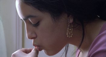 Movie still from “The Secret of the Grain” (2007), directed by Abdellatif Kechiche – A person wearing a pair of earrings; Extreme Close Up shot, Low angle