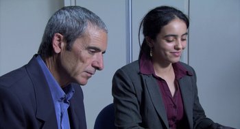 Movie still from “The Secret of the Grain” (2007), directed by Abdellatif Kechiche – A man and a woman sitting next to each other; Medium shot, Over the shoulder angle
